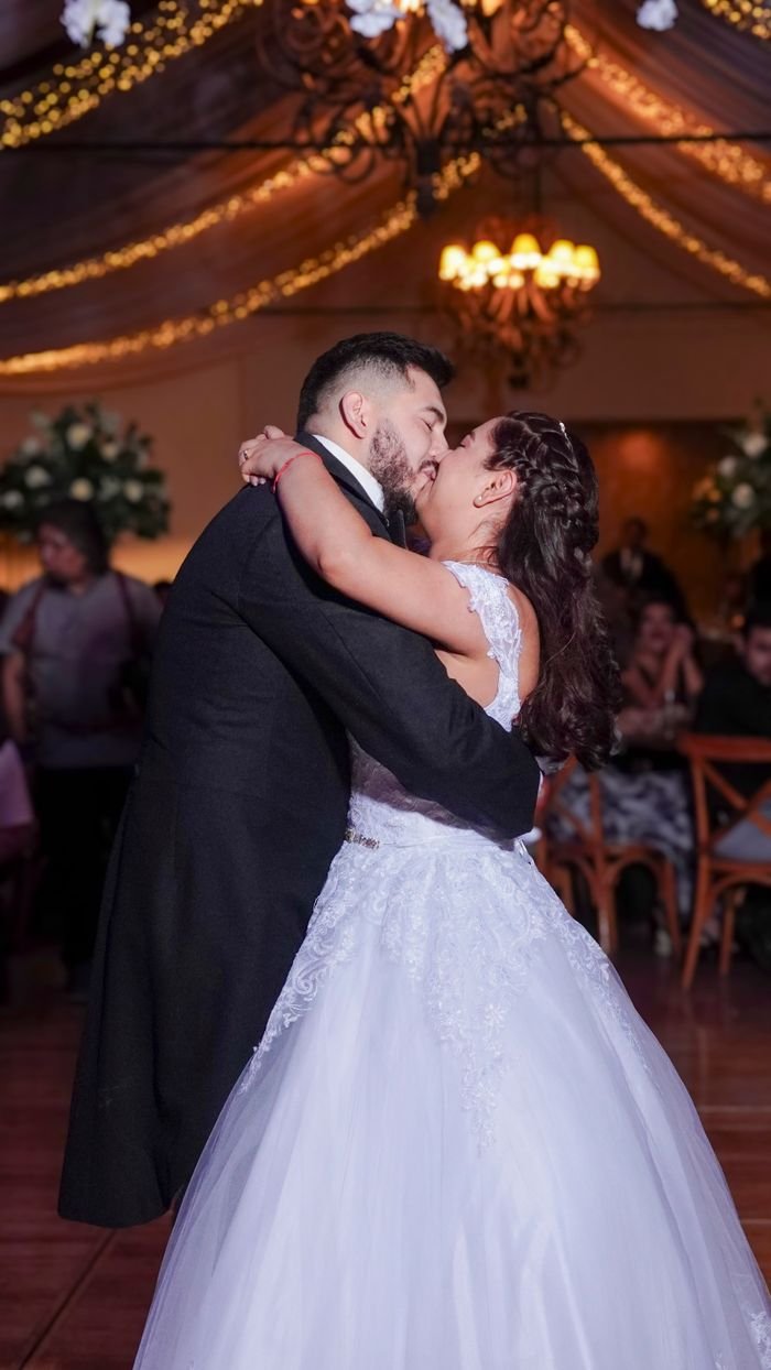 Happy couple shares a romantic first dance at their wedding in Mexico, embracing the joy of marriage.
